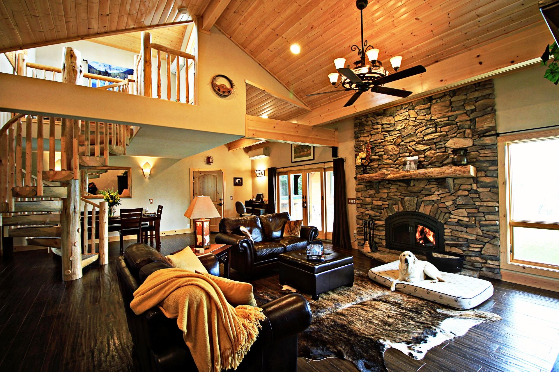 Log spiral stairs to loft at ranch-style California vacation rental